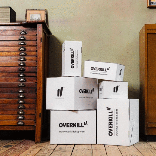  A stack of Overkill boxes next to a dresser, hinting at something exciting coming soon!