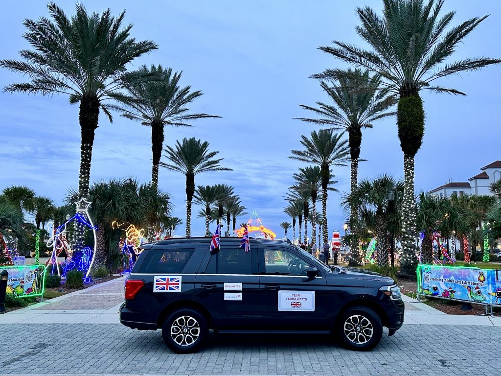Daytona Delivered - Laura's support vehicle parked between palm trees with the british flag on