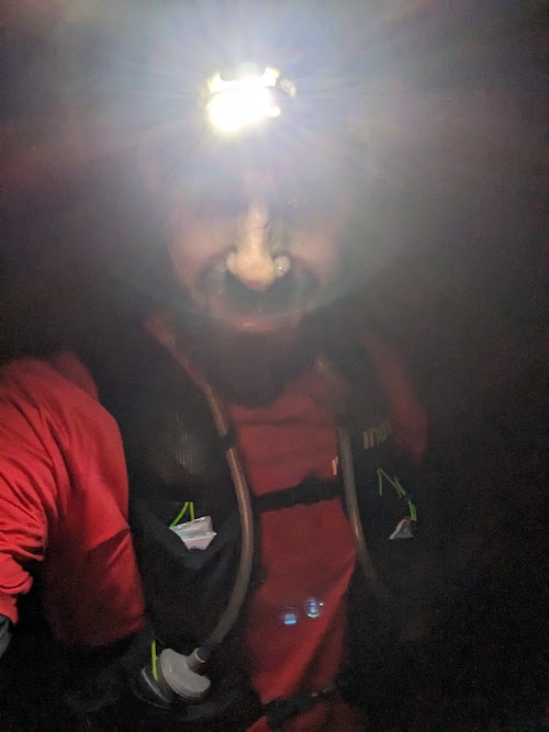 Wild Peak Round 120km Ultra Report Chris taking a selfie in the dark with his head torch creating an interesting light effect