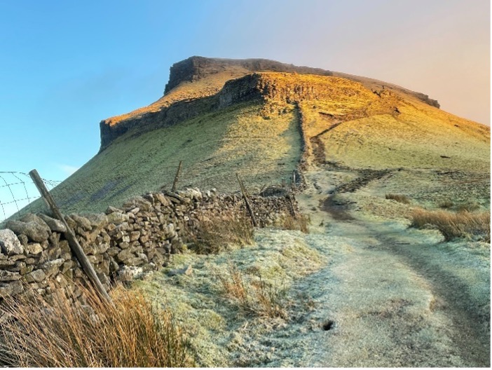 The Backbone - image of the hill called Pen Y Ghent at sunrise on a sunny day