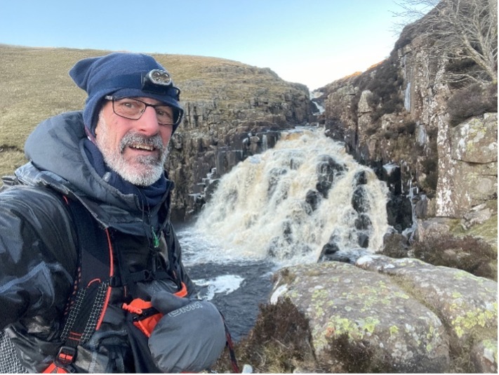 A selfie taken by Bill with a waterfall called Cauldron Snout behind him