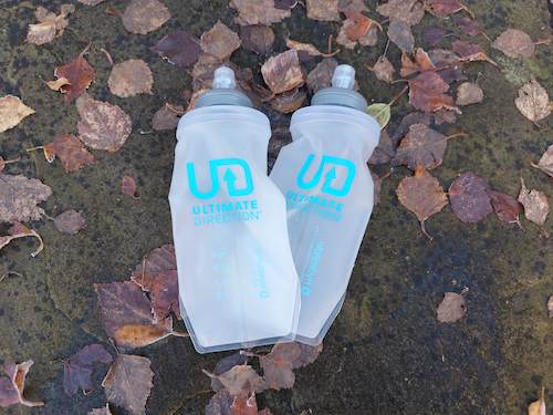 Two water bottles with UD written on them