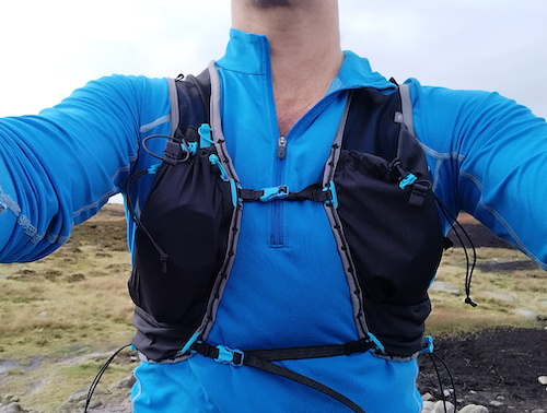 Image of a man wearing a blue top showing the Ultimate Direction Race Vest 6.0 (Signature Series)