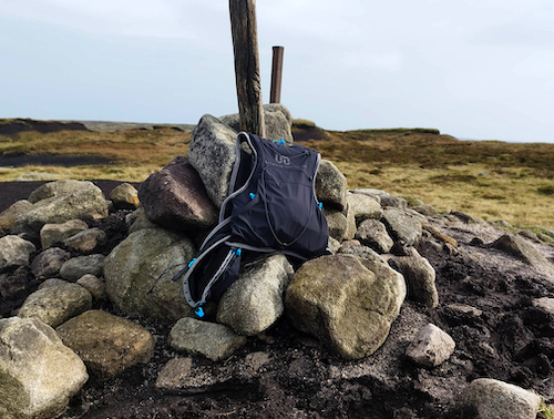 Ultimate Direction Race Vest 6.0 (Signature Series) sitting on a stone cairn
