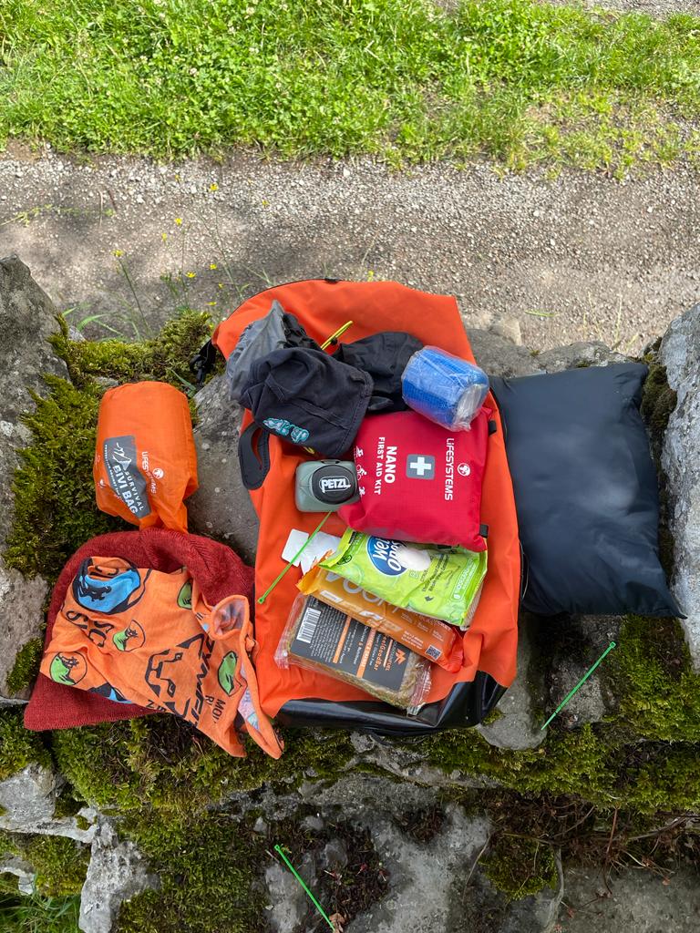 Ultimate Direction Adventure Vest/Vesta 6.0 RunUltra Review Emergency kit laid out on a stone stile